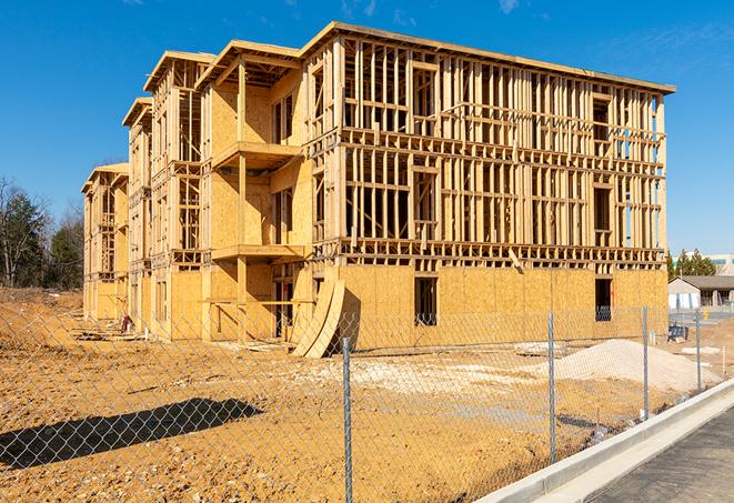 a close-up of temporary chain link fences enclosing a construction site, signaling progress in the project's development in Belmont CA